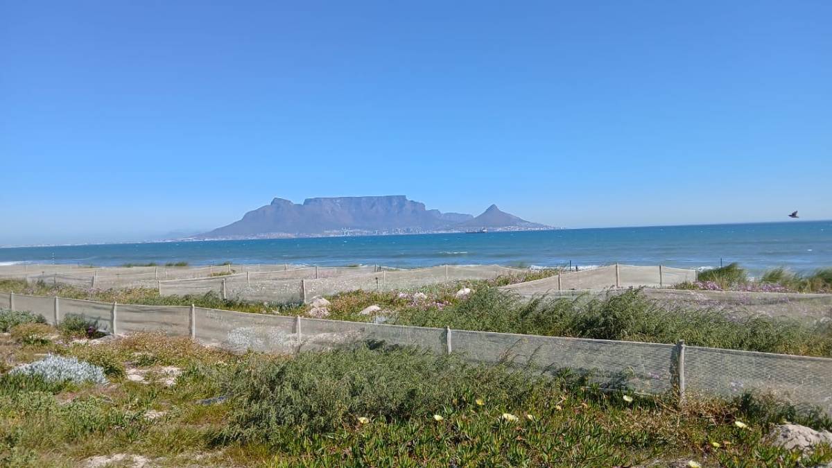 Landscape photo of a mountain in the distance, separated by the sea