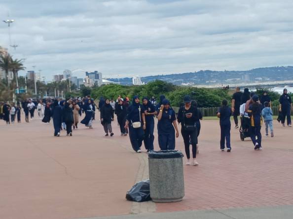 People walking along a wide path.
